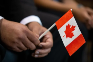 man-holding-small-Canadaian-flag